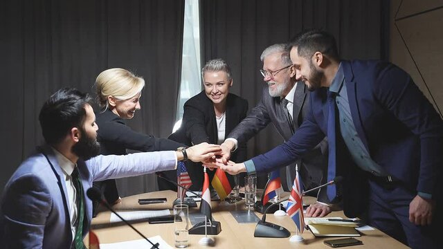 Happy politicians sign an agreement, keep hands together, celebrating, have a good job together.