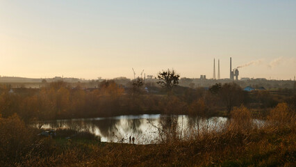 The industrial plant operates and pollutes the environment, nature at sunset. Ecological world catastrophe of factories