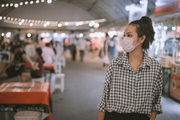 Series photo of young woman tourist wear surgical medical mask touring in street night market , Chiang mai north of thailand