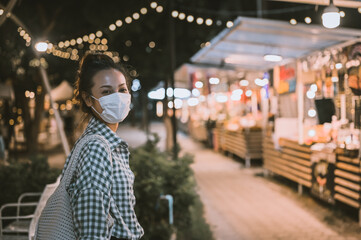 Series photo of young woman tourist wear surgical medical mask touring in street night market , Chiang mai north of thailand