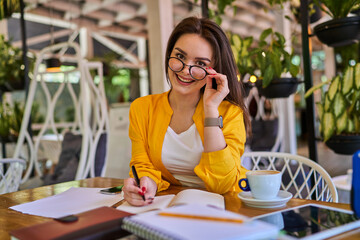 Portrait of preety woman in glasses working in her office