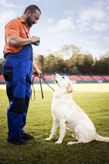 Time to study.Man training his dog.