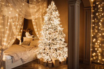 magic warm and cozy evening in Christmas brown white room interior design, Xmas tree decorated lights garland holiday living room.canopy bed arch sofa mirror style New year holidays