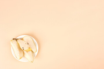 Flat lay composition with ripe pears on pastel yellow background, top view. Space for text