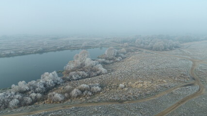Aerial view of the river and fields with frost and fog
