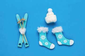 A set of accessories and clothes for skiing on a blue background. Flat lay.