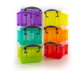 Photo of six stacking transparent plastic rainbow storage bins with lids for home organization