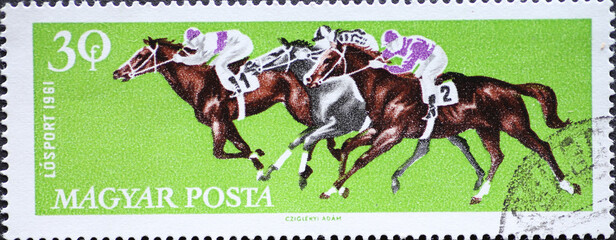 Hungary circa 1961: A post stamp printed in Hungary showing a horse race with Galloping Horses...