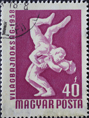 Hungary circa 1958: A post stamp printed in Hungary showing two wrestlers fighting at World...