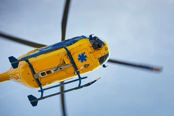 Zelfklevend Fotobehang Flying helicopter of emergency medical service. Themes rescue, help and hope. © Chalabala