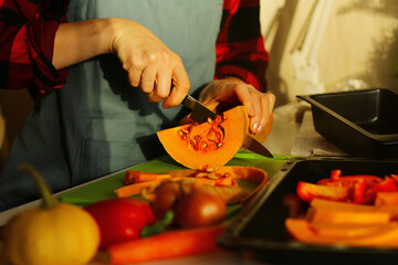 cooking autumn pumpkin soup-puree. preparation of vegetables for baking. Healthy fall vegetables for Halloween season lunch