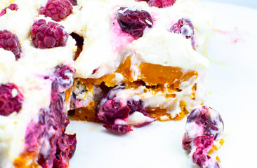 Tasty homemade cake with cream, fresh cherries and raspberry.