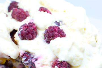 Tasty homemade cake with cream, fresh cherries and raspberry.