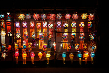 Different shaped & Vibrant colored lanterns displayed in market during festive season of Diwali in Pune city, India.