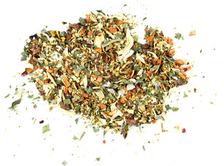 A mixture of seasonings scattered on a white background