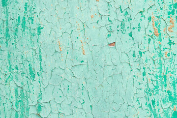 Old cracked green paint on rusty metal