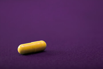 Medical pills. Color capsules medication. Purple background. Health care concept. Free space for text. Medicines. Many different pills. Chemical industry.