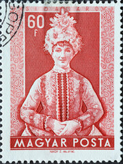Hungary circa 1953: A post stamp printed in Hungary showing a Hungarian folklore costume and...