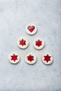 Classic Linzer Christmas Cookies with raspberry or strawberry jam on light background.