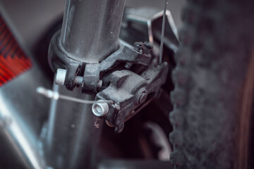 Fototapeta na wymiar Bicycle elements in close-up. Individual parts of a sports bike are in focus. The vehicle parts are covered with dust