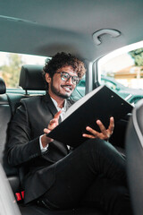 Indian businessman writes down data in a notebook