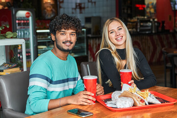 couple a Hindu man and a girl came to a cafe to eat a burger