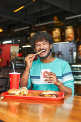 Indian guy eats fast food