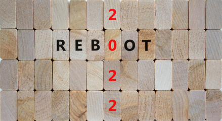 2022 reboot new year symbol. Wooden blocks with words 'Reboot 2022'. Beautiful wooden background, copy space. Business, 2022 reboot new year concept.