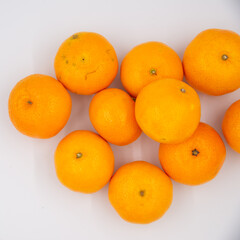 Fresh mandarin or tangerines on white background. Top view, copy space.
