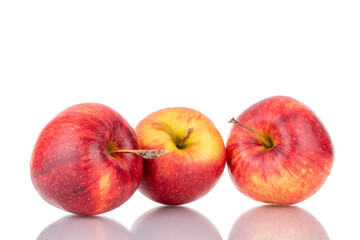 Three juicy red apples, close-up isolated on white.