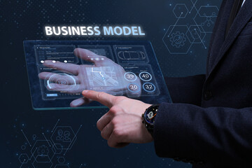 Business, Technology, Internet and network concept. Financial Graph. Stock Market chart. Young businessman working on a virtual screen of the future and sees the inscription: Business model