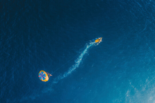 Aerial view of a parafly above the water at sunset, Sicily, Italy.