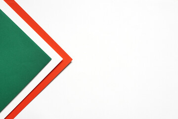 On a white background, an abstract background concept with a geometric pattern of blank green and red paper stacking.