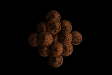 Chocolate truffles on a black background.