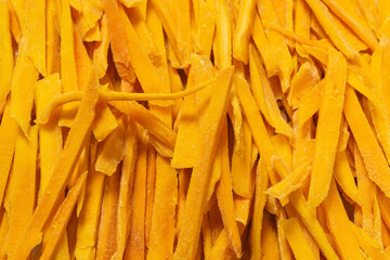 Dry tasty mango slices as a background.