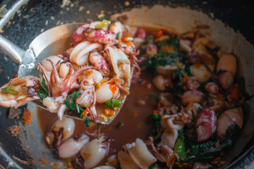 Stir Fried Basil Thai Squid on pan