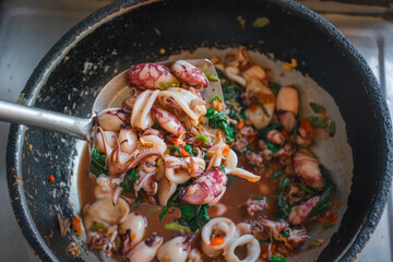 Stir Fried Basil Thai Squid on pan