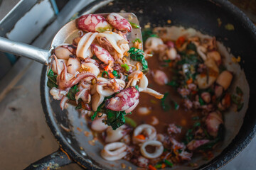 Stir Fried Basil Thai Squid on pan