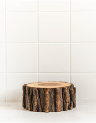 Fototapeta premium Round natural wooden podium mockup for eco, food or beauty product on white tile background.