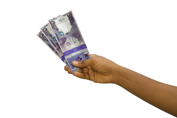 Fair hand holding 3D rendered Qatar riyal notes isolated on white background