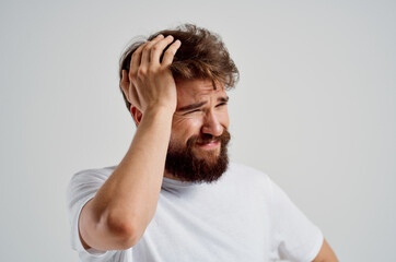 bearded man in a white t-shirt headache migraine problems Studio treatment