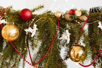 a branch of a Christmas tree with decorations and garlands in the form of deer