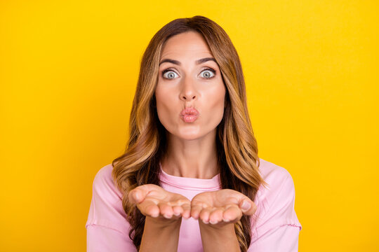 Photo of young attractive woman send air kiss you coquettish date romantic isolated over yellow color background