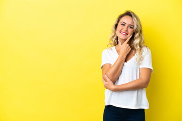 Young Brazilian woman isolated on yellow background happy and smiling