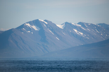 Fototapeta na wymiar Landscape of snow covered mountains in fjord in North Iceland