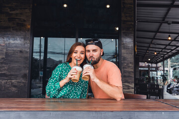 Beauty couple drinking smoothie on cafe hipster style, beard man, woman in the dress, happy face, love romantic,Couple having coffee at a coffee shop. Man and woman meeting at cafe,Attractive smiling