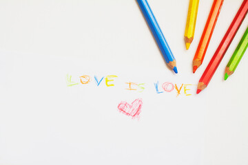 Handmade colored drawing on a white sheet with the text love is love and a red heart, representing the LGBTQ + community 