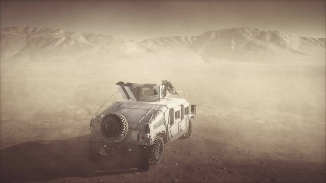 Military patrol car on sunset in desert storm