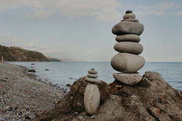 Stones balanced in piles against the sea. Calming mood