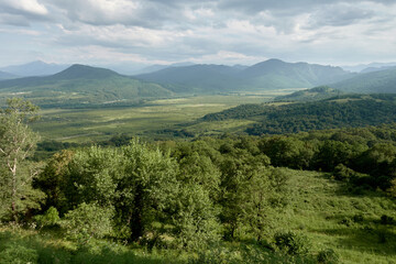 Obraz premium Mountain landscape with green valleys. Caucasian State Natural Biosphere Reserve named after Kh.G. Shaposhnikov. Lago-Naki plateau. Russia.